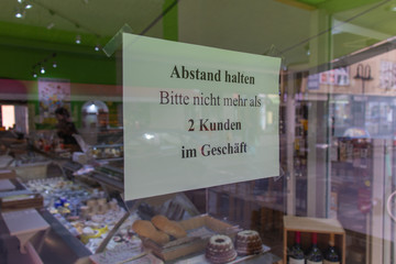 German Sign in front of a store in Frankfurt am Main about the Corona virus pandemic situation