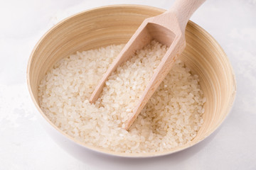 close-up rice in a bamboo bowl on a white background
