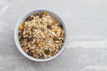 dry muesli in the bowl on ceramic background