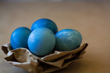 Easter holiday decorations, background. Basket with painted blue eggs, with bars, branches, flowers. Religion.
