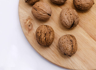 fresh walnuts, superfood, healthy foods, nuts on a wooden surface, close-up