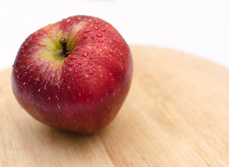 fresh red apples close-up on a light wooden background, healthy health products