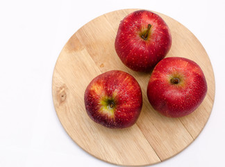fresh red apples close-up on a light wooden background, healthy health products