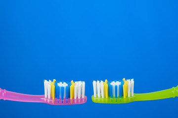 toothbrush green and pink on blue background, couple