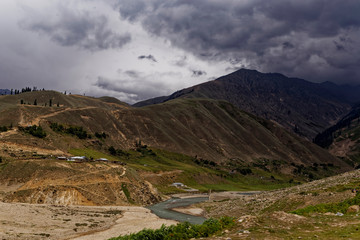 Mountain landscape with river stream and clouds in Pakistan