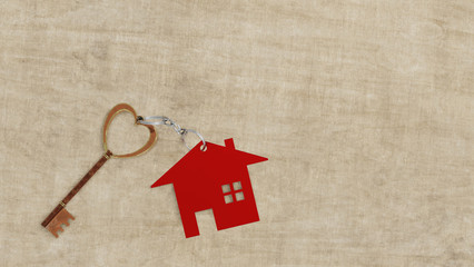 New home with gold Key house and red miniature house on wooden background. Love home. 3d render.