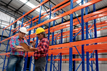 Employees use tablet computer at logistics center warehouse.