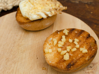 croutons with cheese and eggs for breakfast, food with speckled plan, simple breakfast, light wooden background