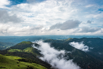 mountain with green grass and beautiful sky