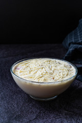 Profiteroles with White Chocolate in Glass Bowl.