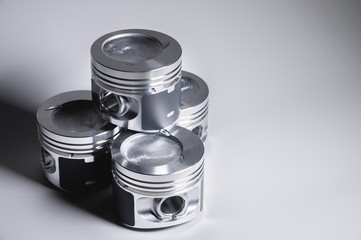 New parts for the internal combustion engine. Pistons on a gray gradient background