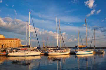 Fototapeta premium Yachts boats in picturesque old port of Chania is one of landmarks and tourist destinations of Crete island in the morning. Chania, Crete, Greece