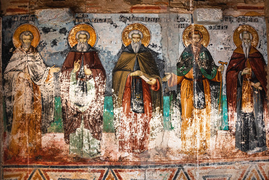 Mount Athos, Greece - October 21, 2019: Timeworn frescoes of saints on the outer side of the Church of Protaton in karyes, Mount Athos.
