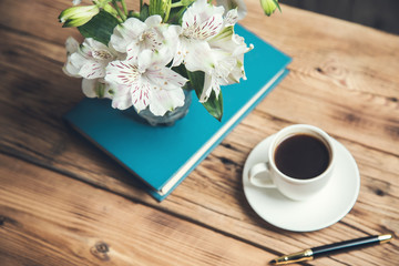 flowers on book  with coffee