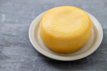 cheese on the small dish on ceramic background