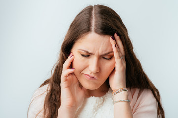 long-haired beautiful brunette girls have a toothache