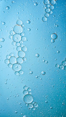 oil with bubbles on dark blue background. Abstract space background. Soft selective focus. macro of oil drops on water surface. copy space. air bubbles in water, Vertical format, social media ready