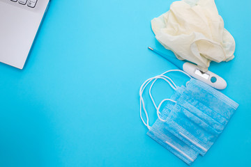 medical mask, gloves and notebook on blue background