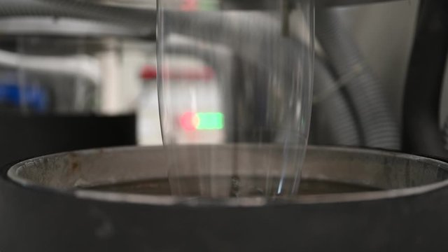 Plastic film making machine Polypropylene Closeup shows the clear plastic material flowing from the die head into a water tray with cold water to cool the plastic and make it beautiful.