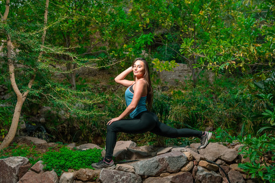 Young woman practicing yoga in the parck
