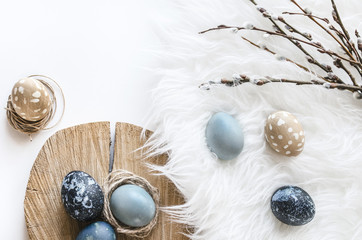 Pastel composition for the holiday of Easter. Colored eggs in natural colors. Background for the presentation of work or text. Top view. Copy space.  Mock-up