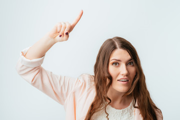 Fototapeta premium Young girl shows the index finger up