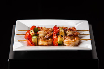  Fried King Prawns Served in Plate, closeup on black background