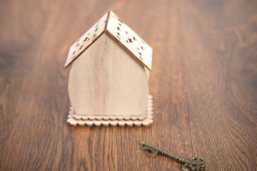 wooden house model and key