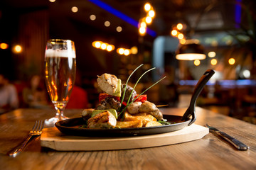 Chicken, pork and beef meat skewers with vegetables and spicy potatoes