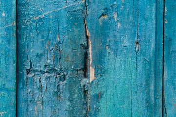 Fototapeta na wymiar Vintage boards painted with colored paint on the peeling surface. Weathered coating of wood material.