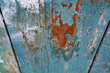 Vintage boards painted with colored paint on the peeling surface. Weathered coating of wood...