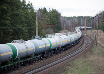 Freight train with petroleum tank cars on railroad. Rail cars carry oil and ethanol. Railway...