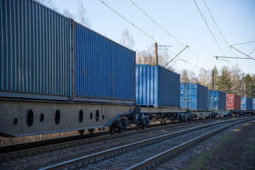 Fototapeta na wymiar Cargo containers transportation on freight train by railway. Coronavirus Wreaks Havoc On Global Industry. Global economy is heading into a recession thanks to the widening fallout from the COVID-19