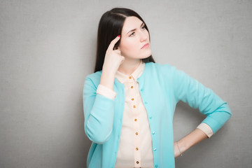 portrait of a worried young woman with a pensive gesture