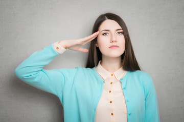 female military salute gesture. isolated on gray background