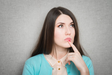 Closeup of young business woman pointing at copy space, isolated