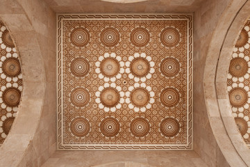 Beautiful ceiling with carved plaster decoration and marble walls.