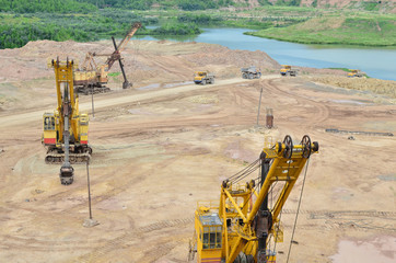 Huge excavators with electric shovel working in the quarry. Big dump trucks transport of minerals in the limestone open-pit mining. Largest dolomite deposit open-cast Gralevo, Belarus, Vitebsk region