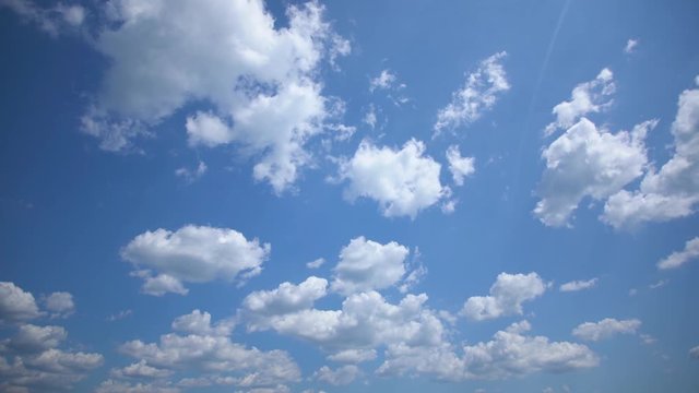 Video timelapse of beautiful clear sunny blue sky with soft fluffy white clouds moving along. Natural background.