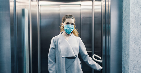 Person wearing face mask is using elevator  © seligaa