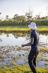 young man hand fishing in the kwai river in botswana africa