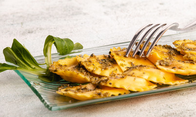 Italian stuffed pasta ravioli with pesto sauce
