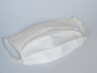 Obraz premium Sewing a protective medical mask to protect against COVID-19. Handmade (Do-it-yourself) cotton medical mask.