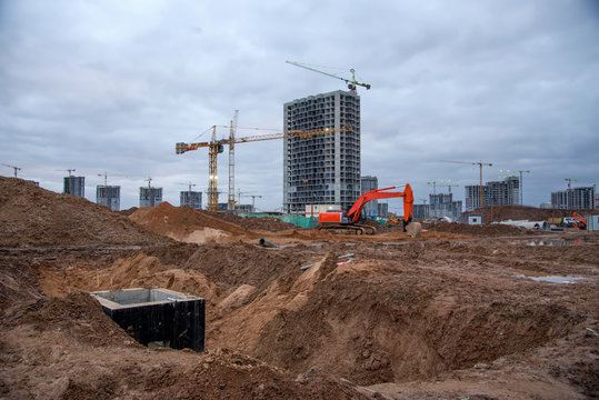 Excavtor and bulldozer digg ground at construction site for the construction of the road. Dozer during land clearing and foundation digging. Drainage manhole form work and rebar work