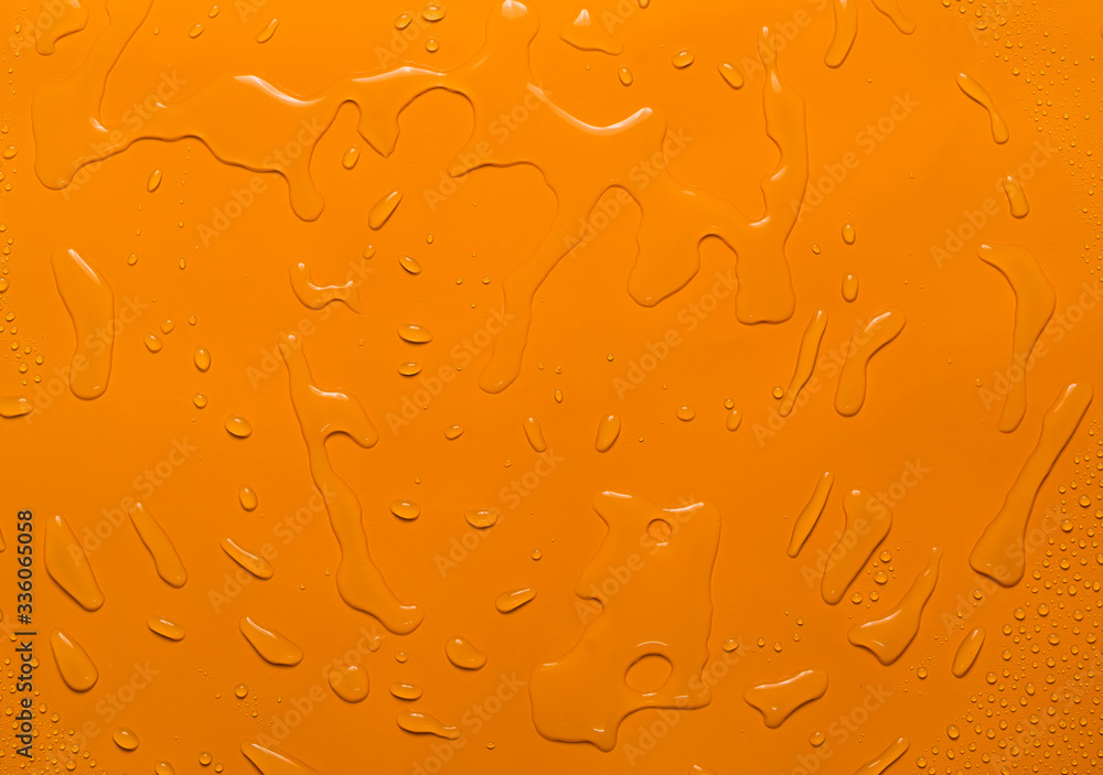 Wall mural close-up water drop orange background