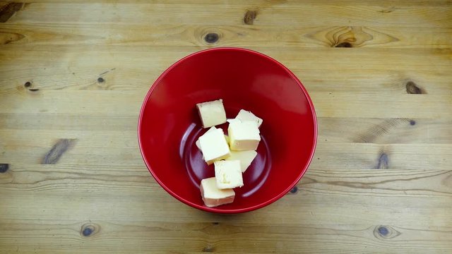 putting butter and suger into a bowl for making a dough