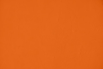 Saturated orange colored low contrast Concrete textured background with roughness and...