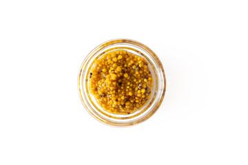 French mustard sauce in glass bowl isolated on white background, above. Seasoning and dip