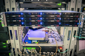 Front panel of central data server. Powerful computing equipment works in the server room. Rack with hosting servers of large web projects. Information Technology Concept