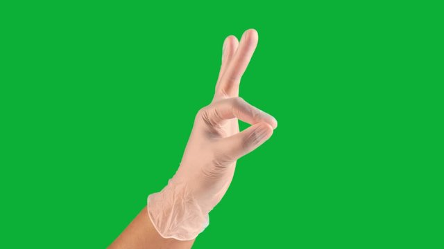 male hand on green chromakey in vinyl gloves ok and thumbs up gesture one click keying